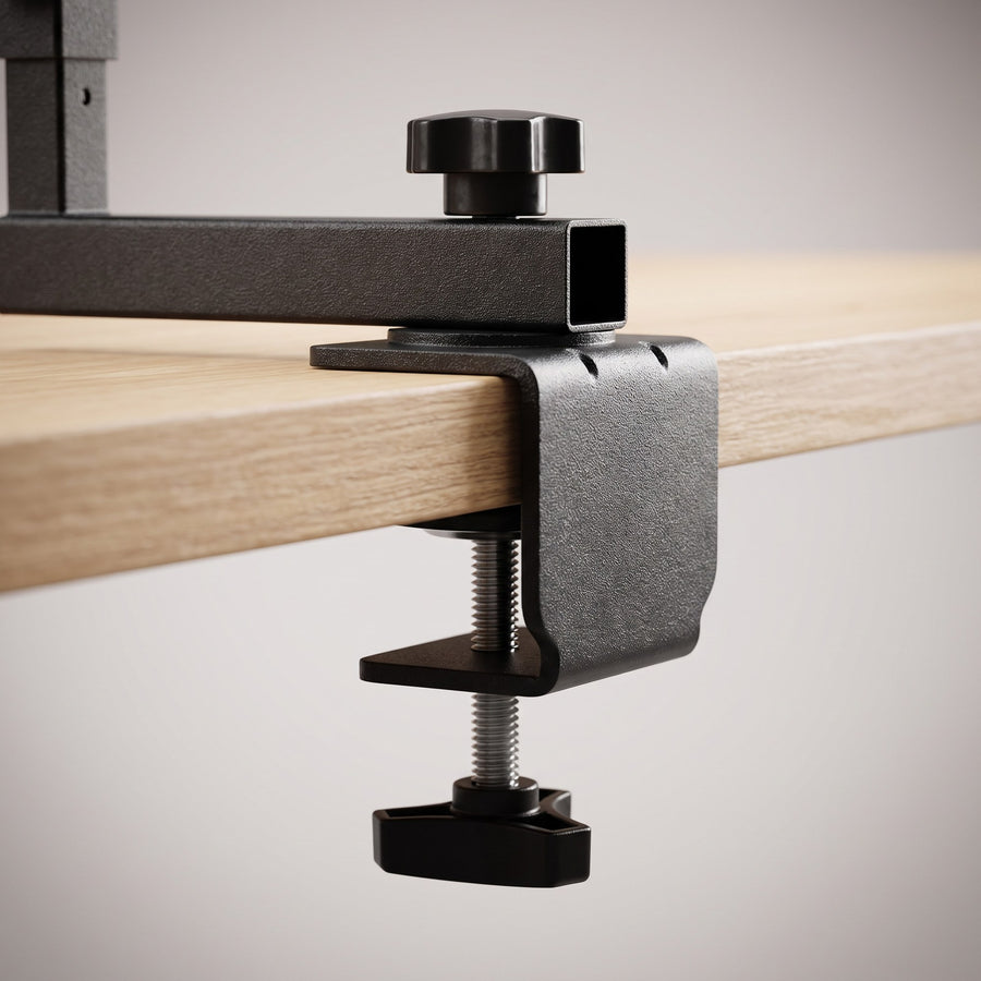 Close-up of the steel clamp gripping a desk edge